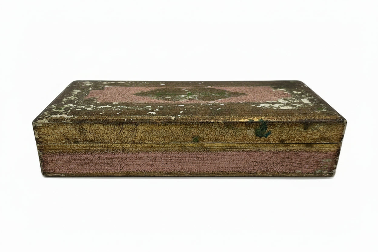 Florentine gilt-wood hinged box closed, distressed gold-leaf lid with faded pink and worn finish, pink sides