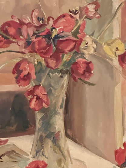 Close-up of the painting's red and pink tulips in a glass vase, in loose painterly brushwork.