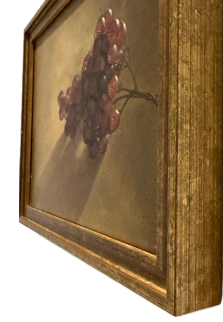 Angled close-up of grapes painting corner showing gilt frame and red-purple grape cluster