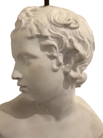 Close-up profile of the plaster youth bust showing curled hair and bare shoulders