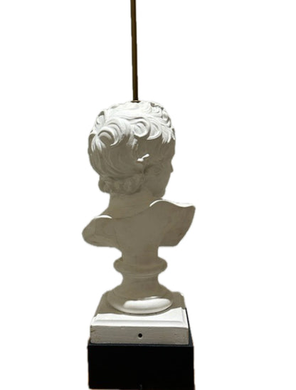 Rear view of the plaster youth bust showing curled hair, mounted on a black plinth