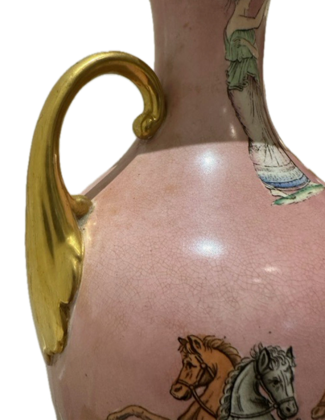 Close-up of the gold scroll handle and crackled glaze on a pink ceramic lamp