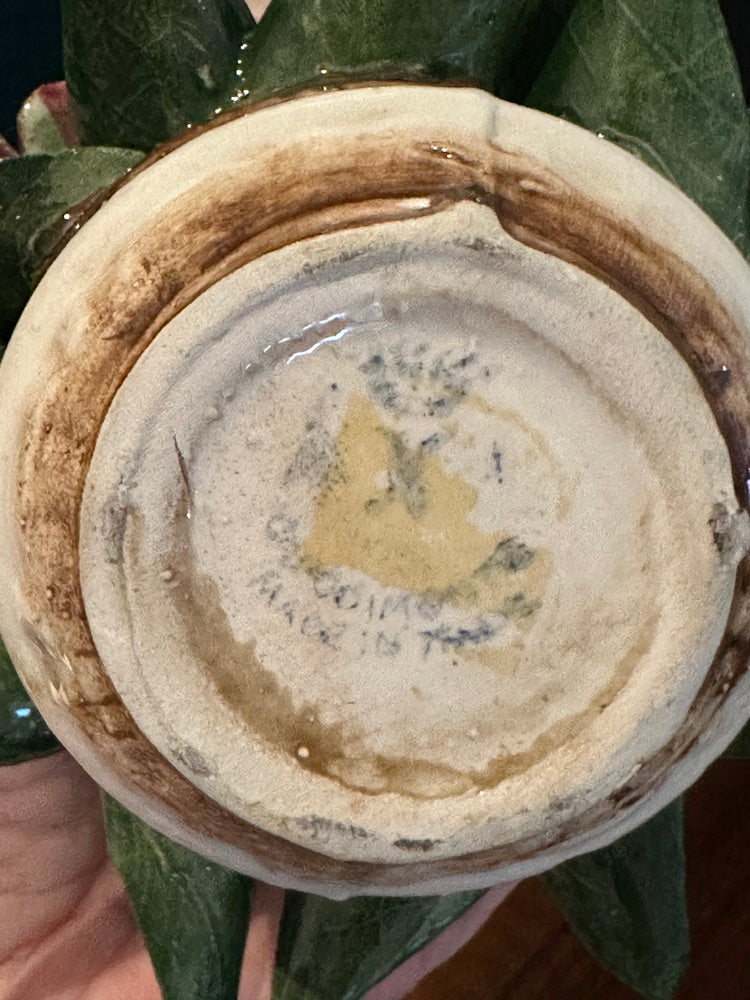 Underside of Capodimonte arrangement showing glazed base and partial 'Made in Italy' maker's mark