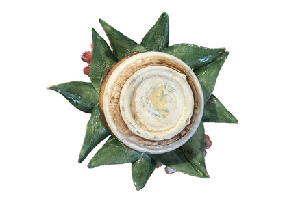 Top-down view of Capodimonte arrangement showing glazed underside framed by radiating green leaves