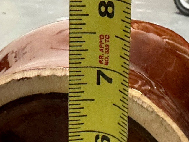 MCM vase base beside a tape measure indicating roughly 7 inches across.