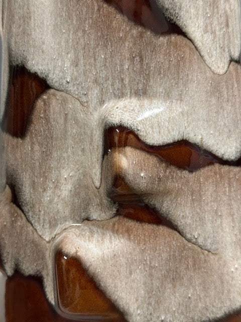 Close-up of the vase's drip glaze texture, frothy cream glaze flowing over glossy reddish-brown.