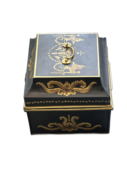 Vintage tole hinged box, angled view showing the brass handle and gilt foliate decoration on lid and side