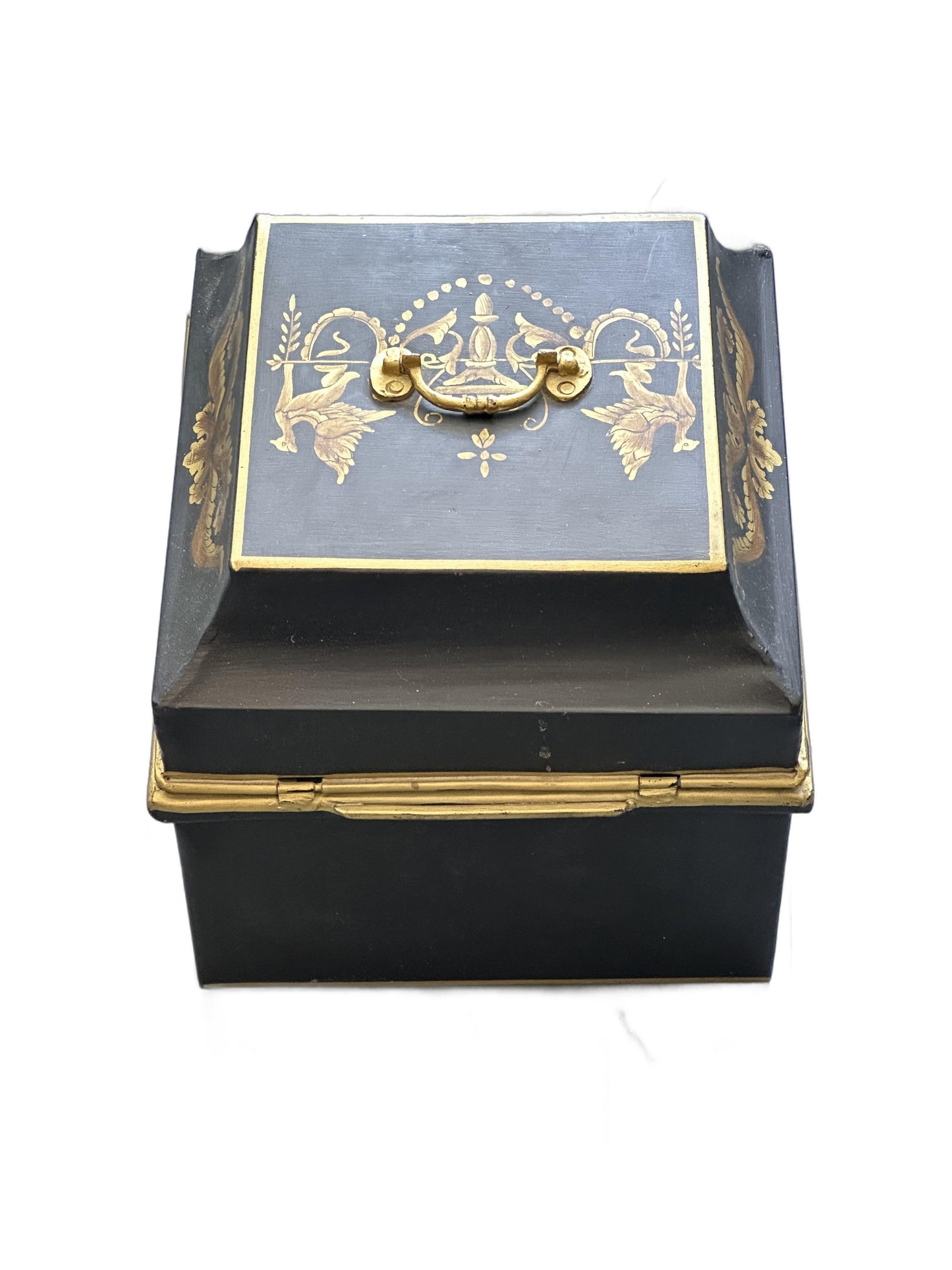 Vintage tole hinged box, angled top-side view with brass handle and gilt motifs