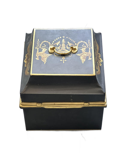 Vintage tole hinged box, angled top-side view with brass handle and gilt motifs