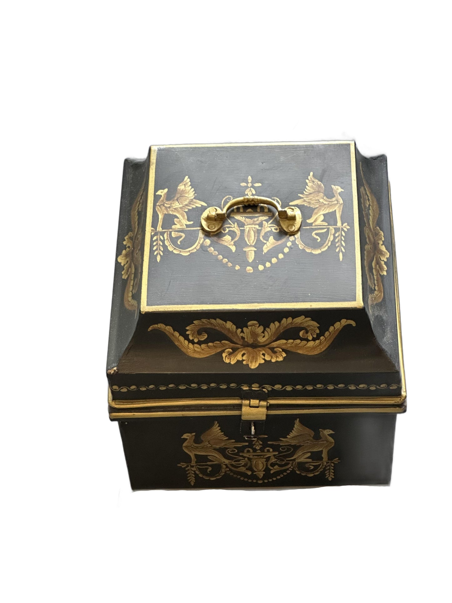 Vintage tole hinged box, top-front view with raised brass handle and gilt griffin motif on the front