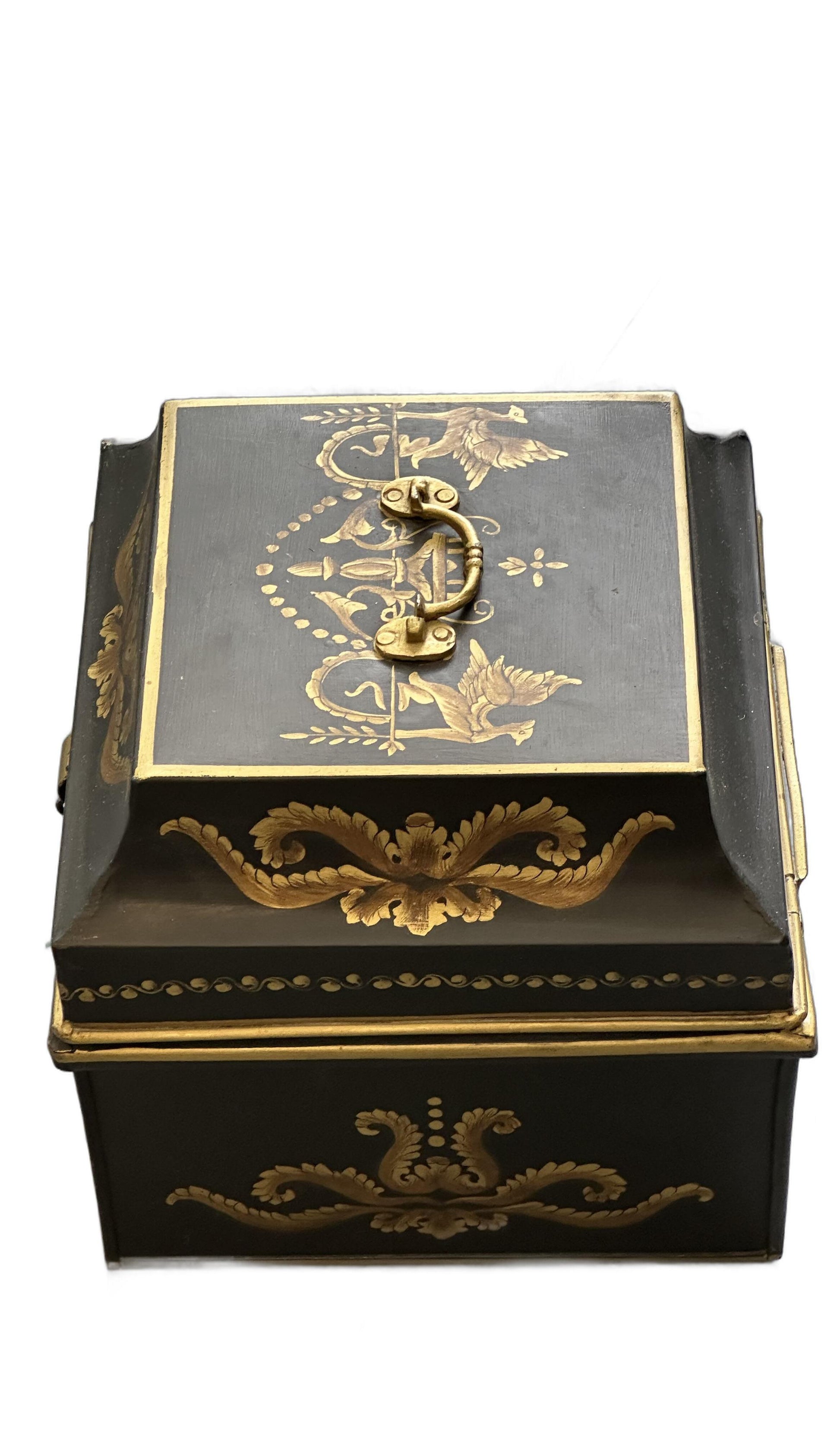Vintage tole hinged box, angled top view with brass handle and gilt bird-and-foliate lid decoration