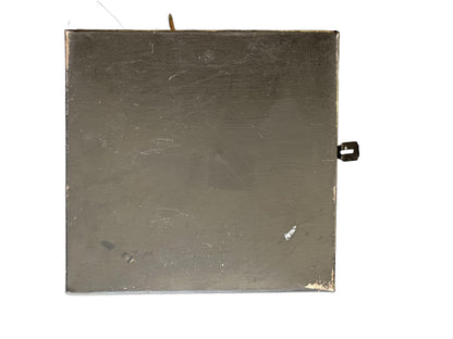 Vintage tole hinged box, base view; bare scratched sheet-metal underside with a small metal latch tab