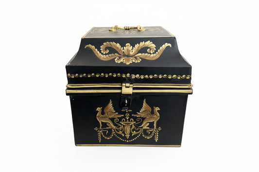 Vintage tole hinged box, front view; black metal with gilt griffins flanking an urn motif and a foliate swag on the lid