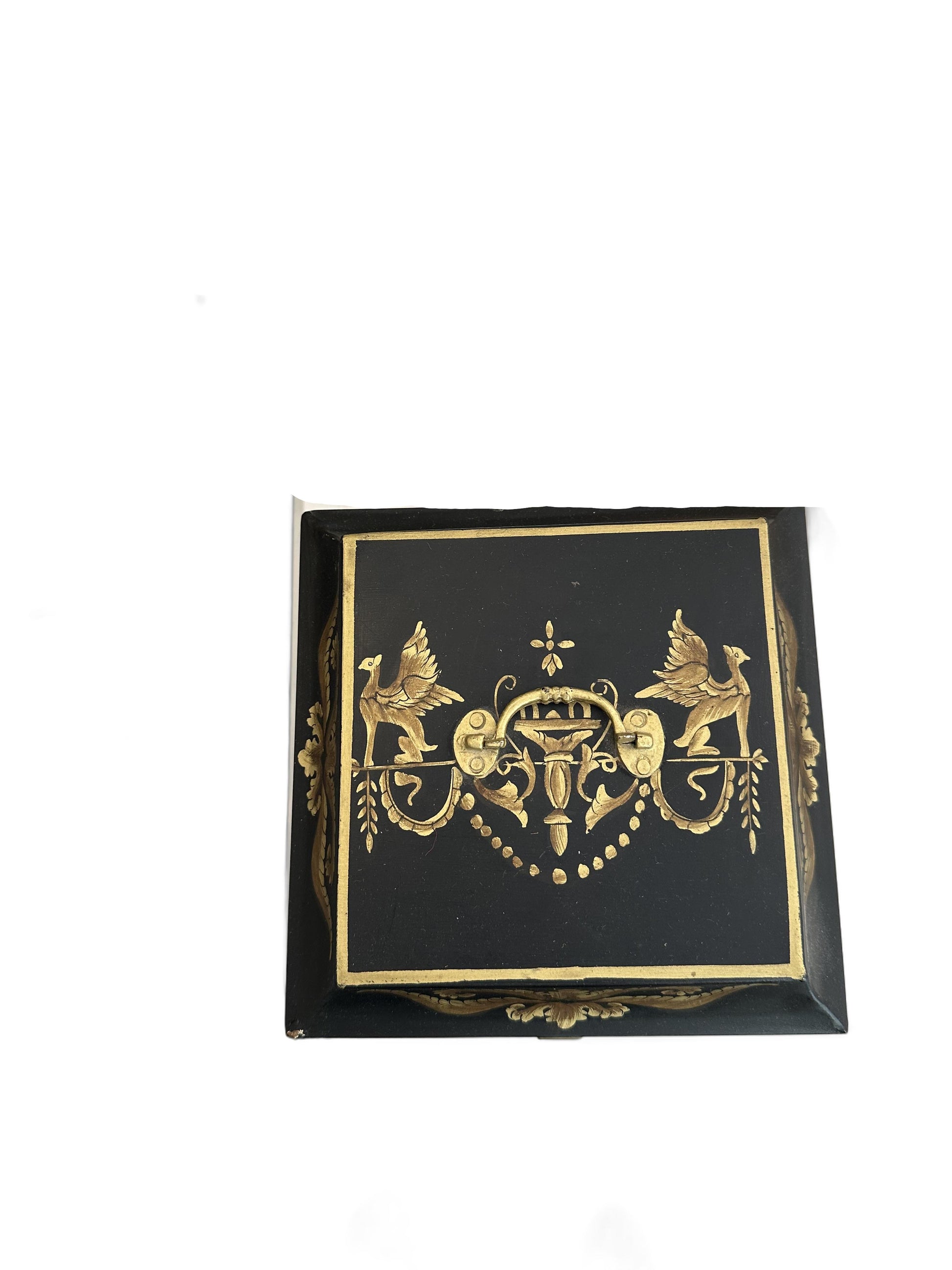 Vintage tole hinged box, top view of the lid with gilt griffins flanking a central urn motif