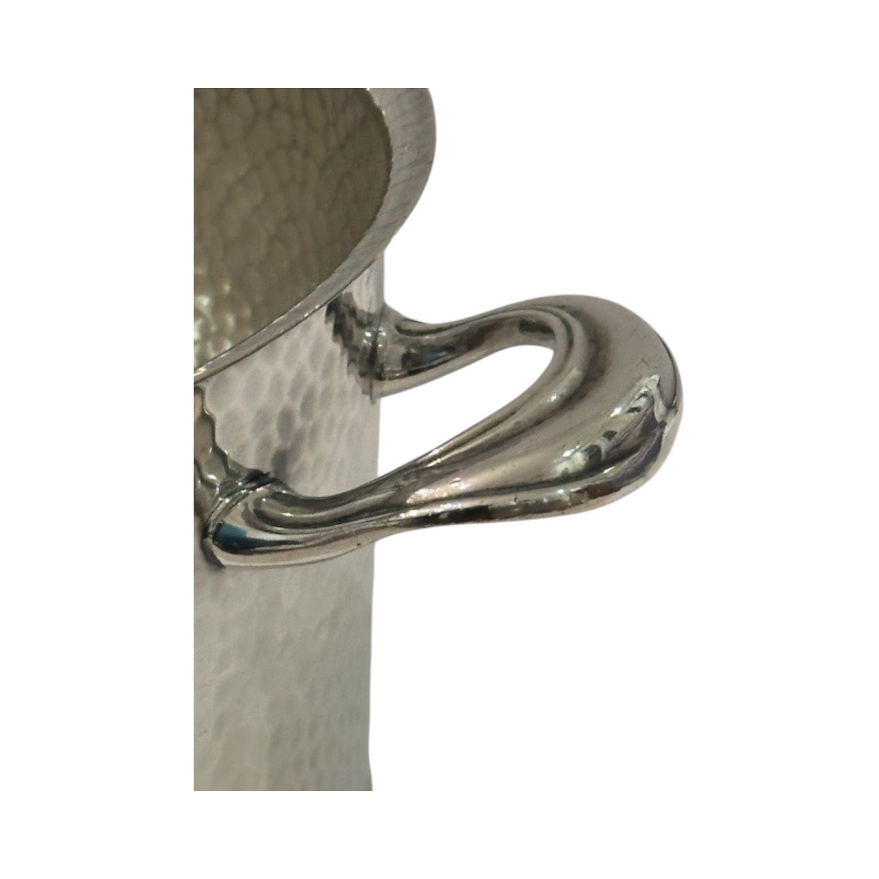 Hammered silver-plate ice bucket; close-up of one polished scroll side handle