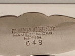 Close-up of the ice tongs' maker's mark: Wm Rogers, Hamilton, Canada, EPNS