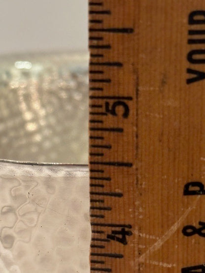 Hammered silver-plate ice bucket; rim measured against a wooden ruler near the five-inch mark