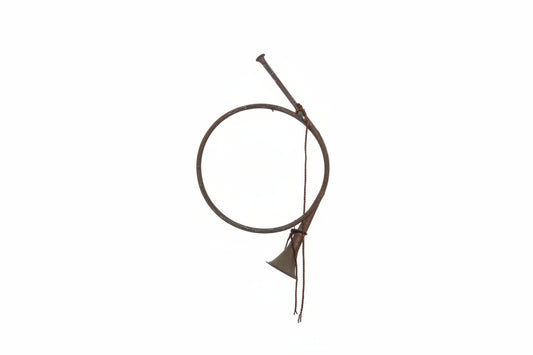 Vintage decorative French hunting horn; single coiled metal loop with flared bell, mouthpiece and cord.