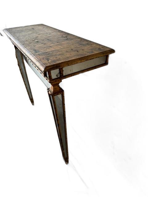 Italian pier table, three-quarter view showing distressed wood top and mirrored legs