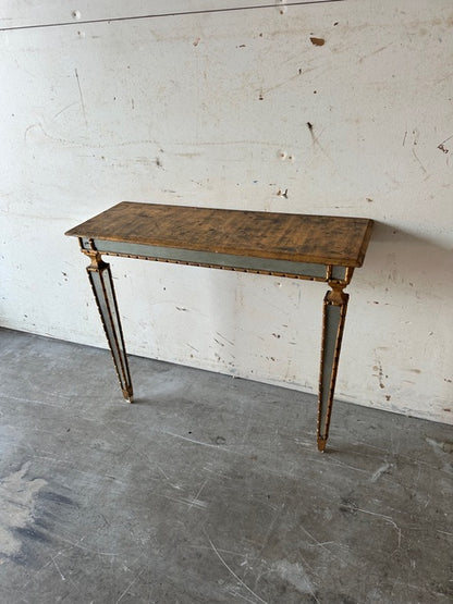Italian pier table, three-quarter view against a wall showing tapering mirrored legs