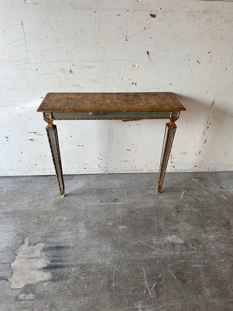 Italian pier table, three-quarter view against a wall with gilt and mirror detailing