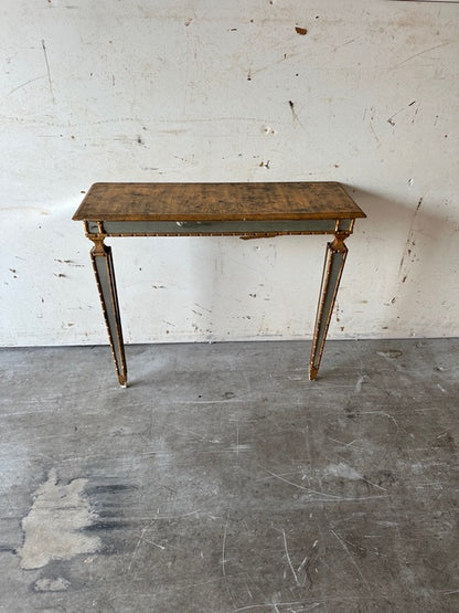 Italian pier table, three-quarter view against a wall with gilt and mirror detailing