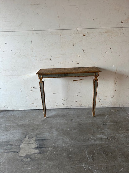 Italian pier table, front view against a wall showing full tapering mirrored legs