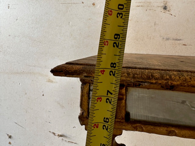 Close-up of the pier table's gilt apron edge with a tape measure near 28 inches