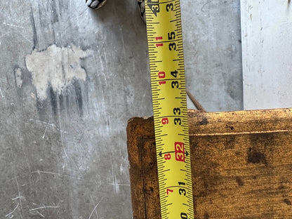 Close-up of the pier table's leg base with a tape measure showing height near 32 inches