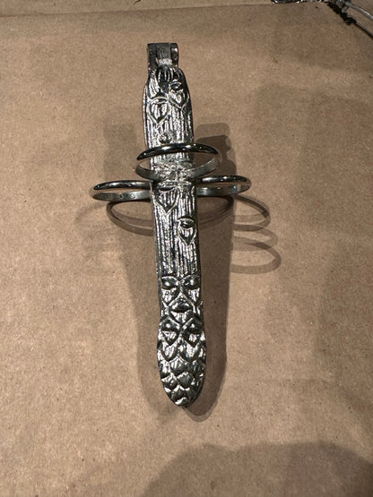 Hinged silver plate asparagus utensil with ornate foliate handle and three finger loops
