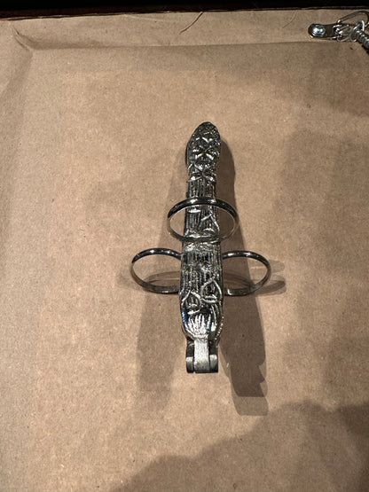 Silver plate asparagus utensil showing embossed handle, three finger loops, and hinged grip