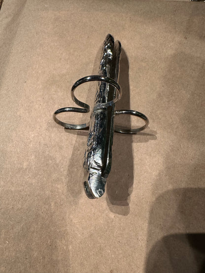 Side view of a hinged asparagus utensil showing its folded form and three finger loops