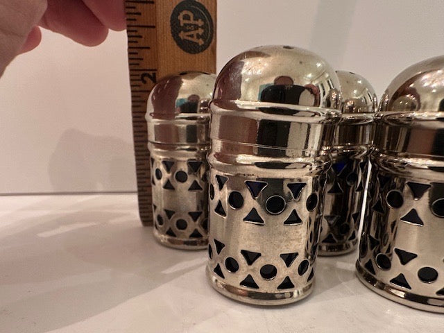 Pierced EPNS shakers beside a wooden ruler showing about two inches tall