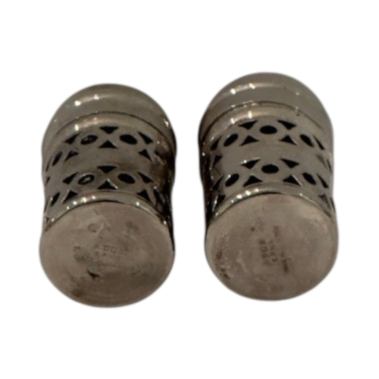 Two EPNS shakers on their sides showing pierced bodies and marked silver bases