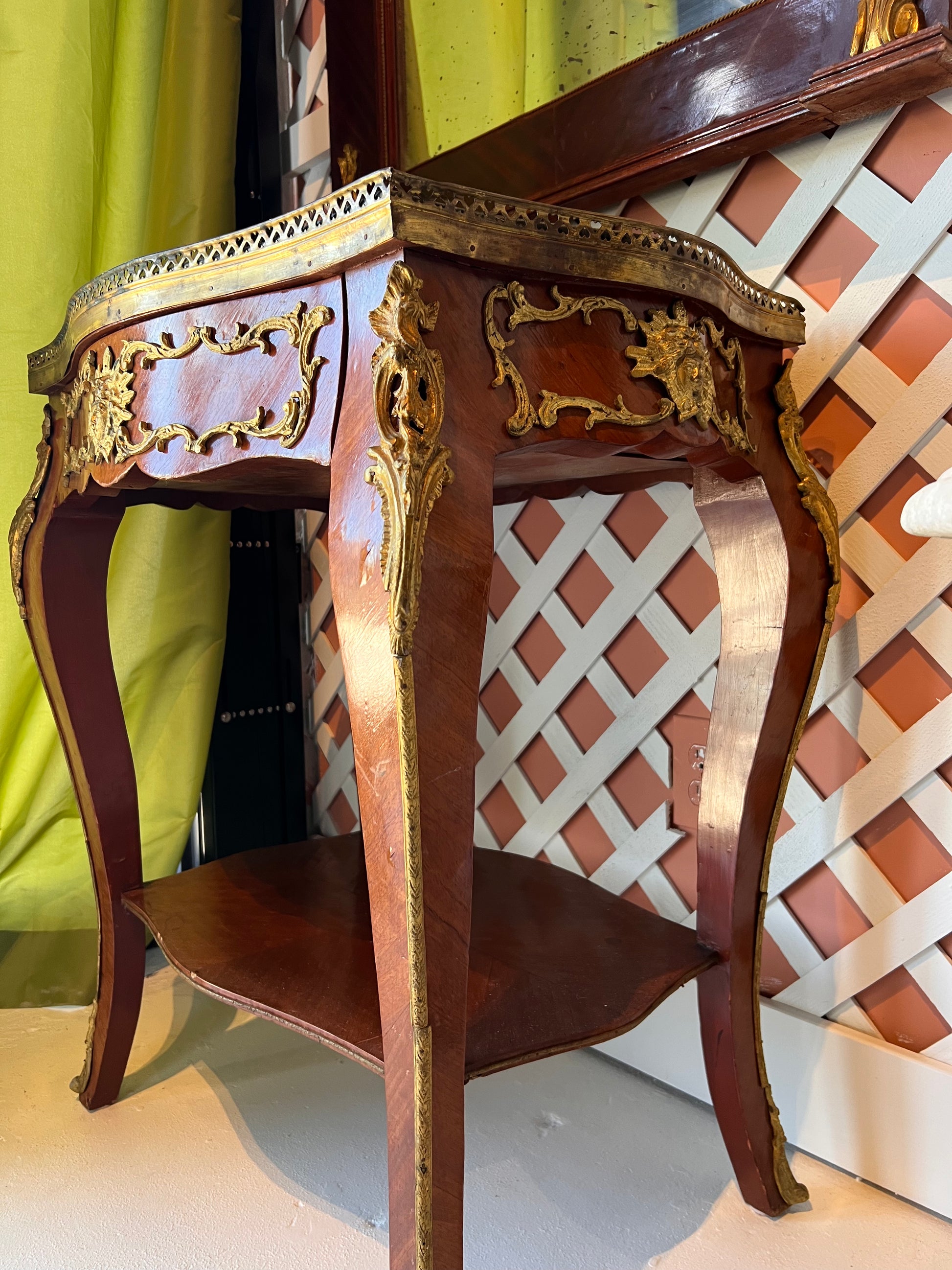 Marble-top side table in situ at an angle, mahogany with gilt ormolu mounts and lower tier