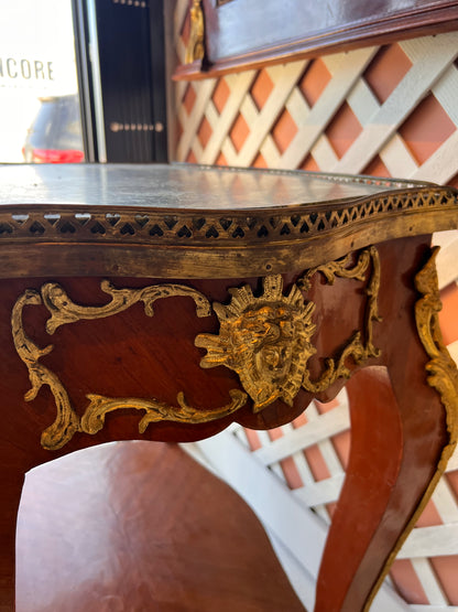 Close-up of the side table's apron with gilt ormolu mask mount and green marble gallery edge