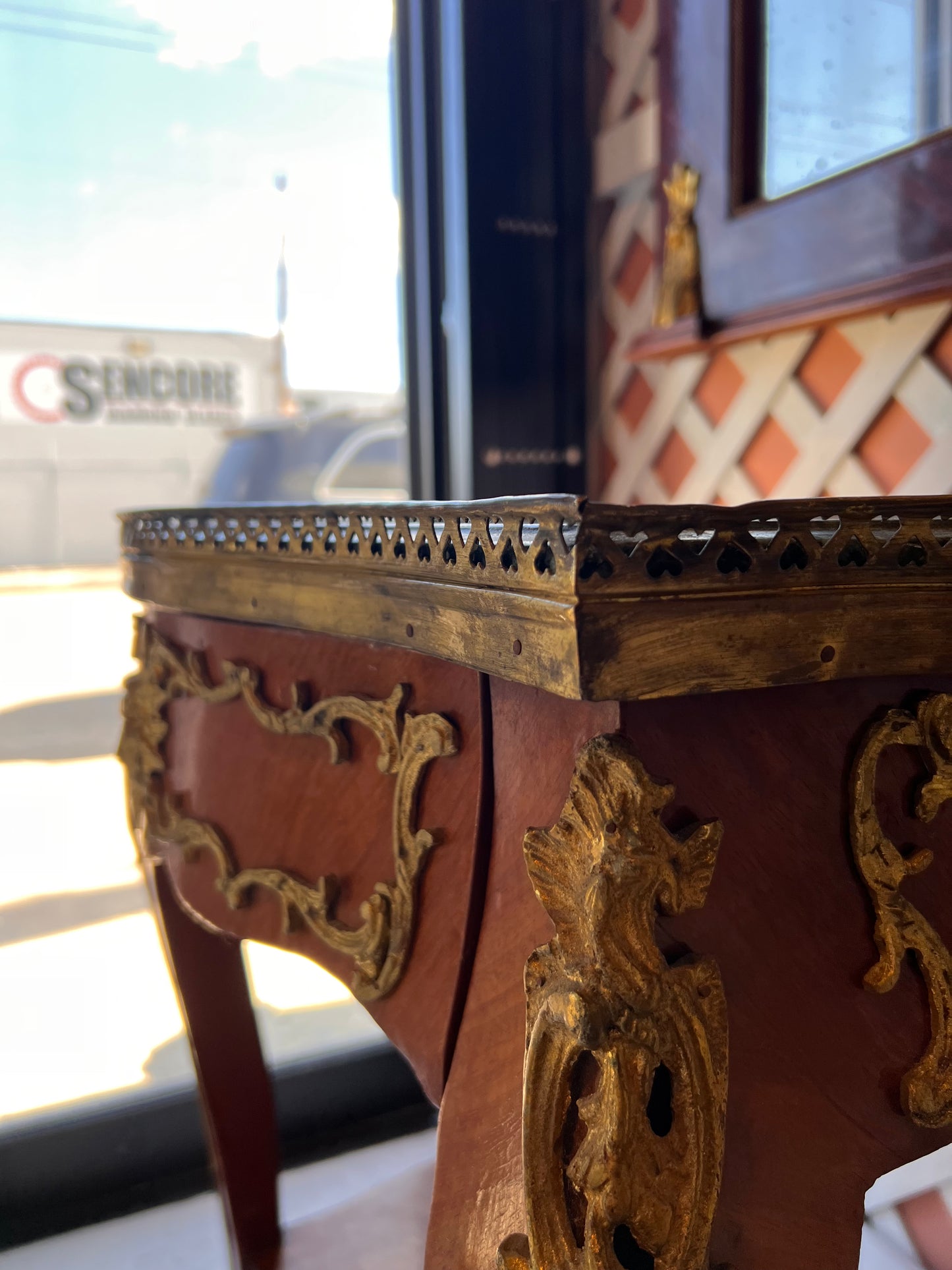 Corner close-up of the side table's pierced brass gallery and ormolu mounts