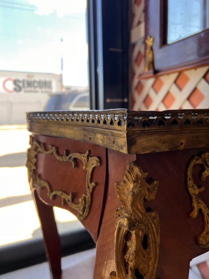 Corner close-up of the side table's pierced brass gallery and ormolu mounts