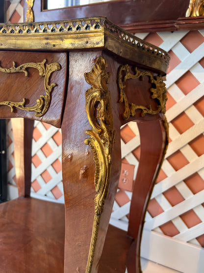 Close-up of the side table's leg and apron with gilt ormolu scrollwork mounts