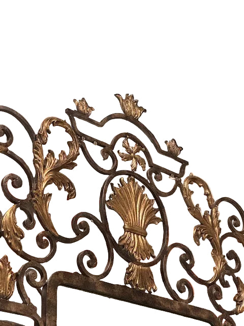 Close-up of the La Barge mirror's crest: gilt wheat-sheaf medallion amid wrought-iron scrolls and gilded acanthus.