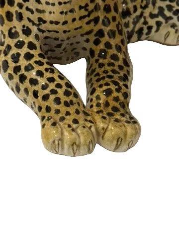 Close-up of majolica leopard's front paws with painted toe and claw detail