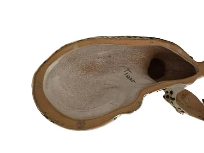 Underside of majolica leopard showing unglazed base and hand-painted signature