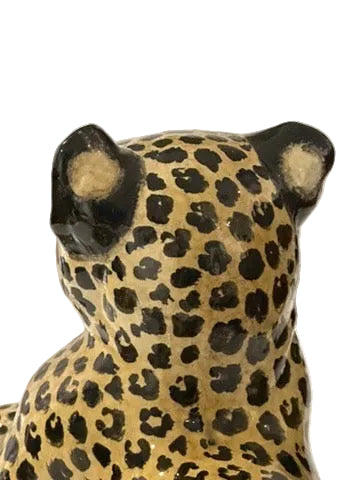 Close-up of majolica leopard's ears and spotted head viewed from behind