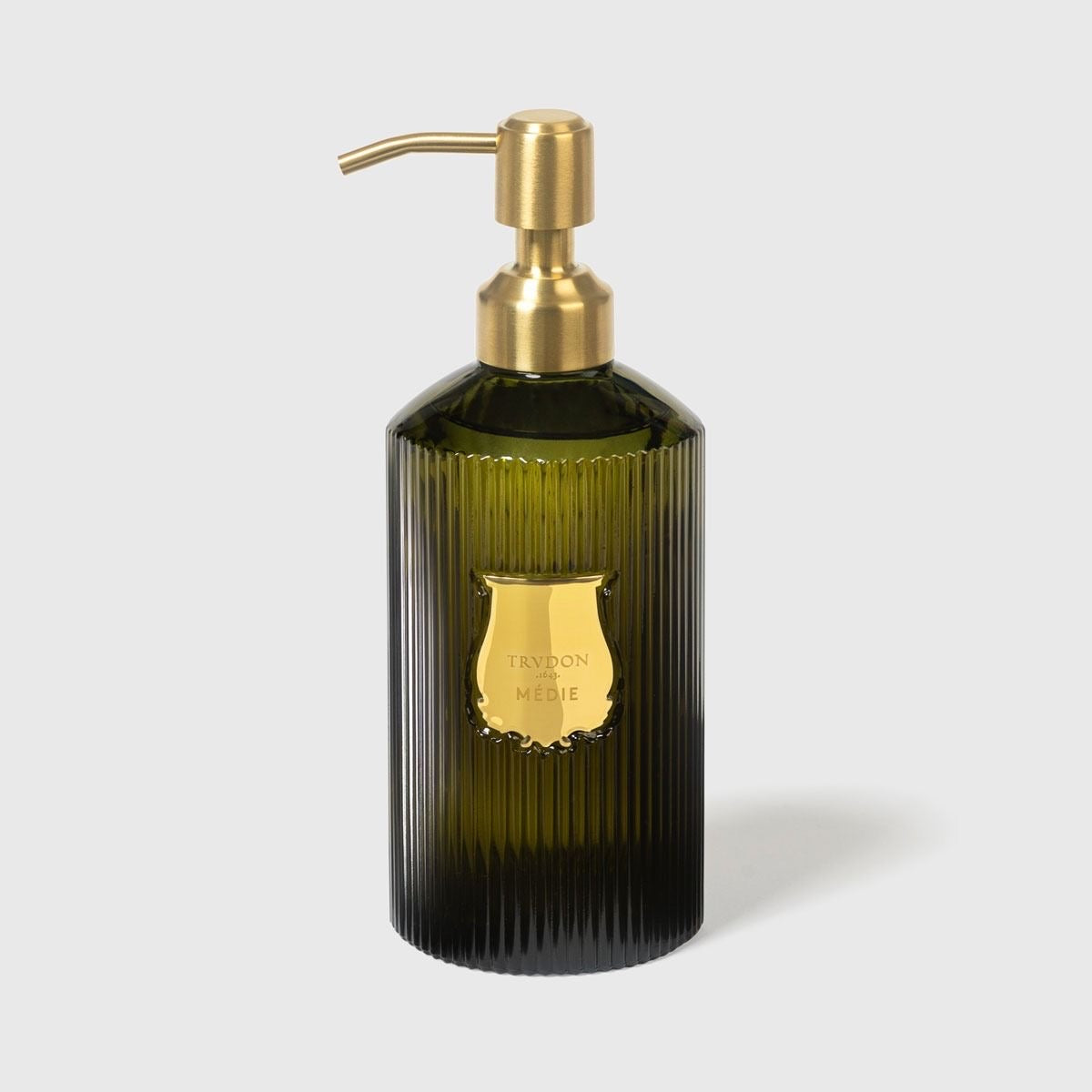 Trudon Medie hand soap in ribbed dark green glass bottle with brass pump and gold Trudon shield label
