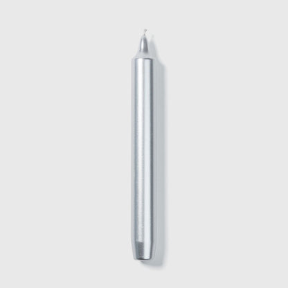 Trudon Madeleine silver taper candle standing upright, metallic silver tapered column
