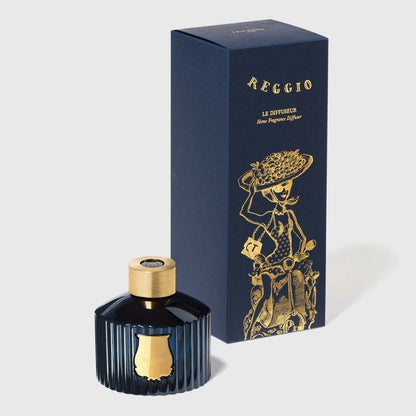 Trudon Reggio diffuser bottle beside navy gift box with gold scooter illustration, citrus scent