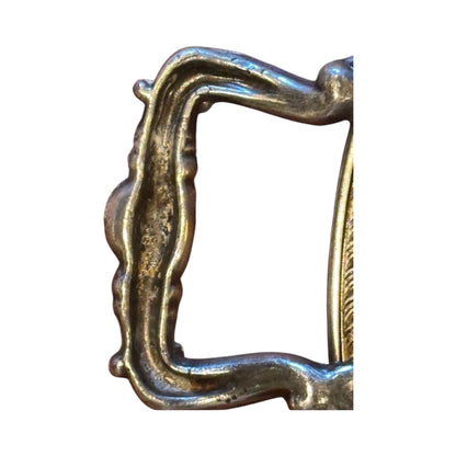 Detail of round silver-plate tray's pierced scrollwork handle