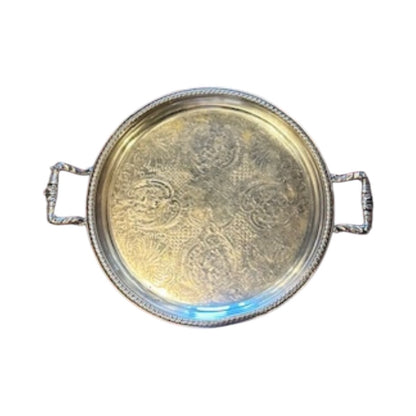 Vintage round silver-plate tray, top view of tarnished engraved center with ornate handles