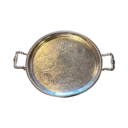 Vintage round silver-plate tray, top view showing engraved scrollwork center, gadroon rim and two ornate handles