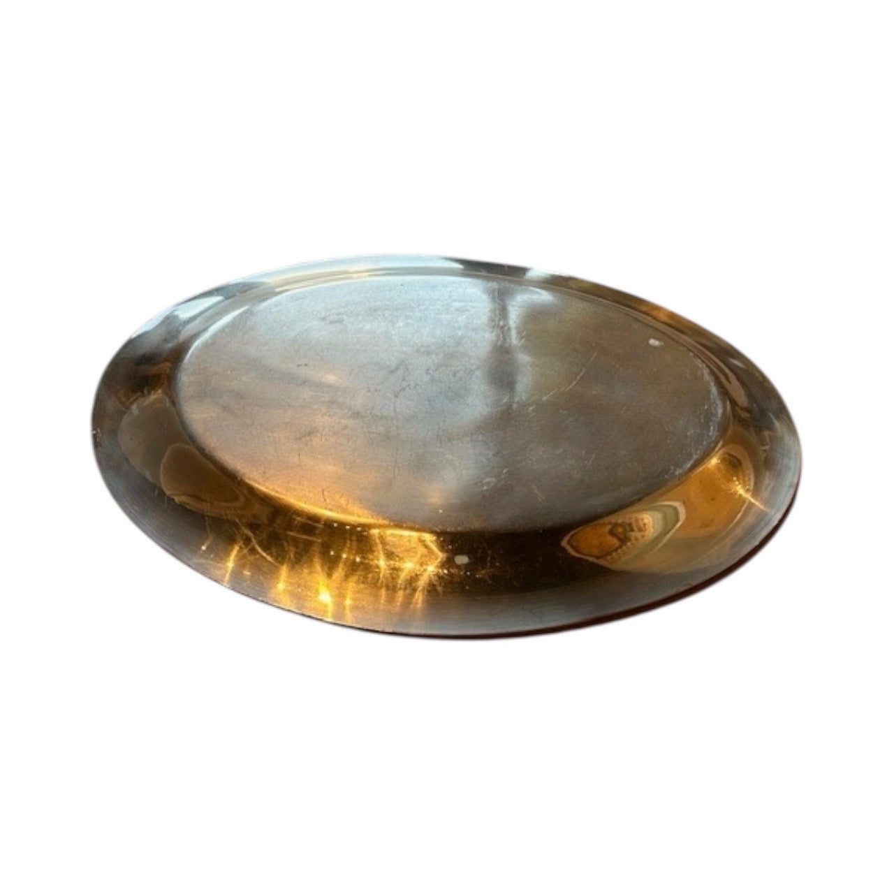Oval silver-plate tray at an angle showing reflections and light surface patina.